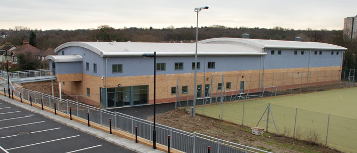 large amenity building with car park